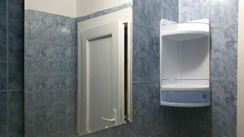 a bathroom with a white cabinet and a mirror at 4U Apartment - Gurko in Burgas City