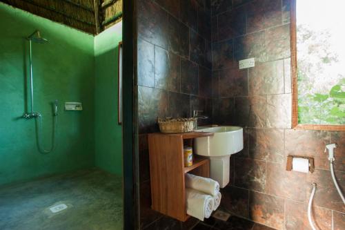 a bathroom with a sink and a shower at Selous Kinga Lodge in Kwangwazi