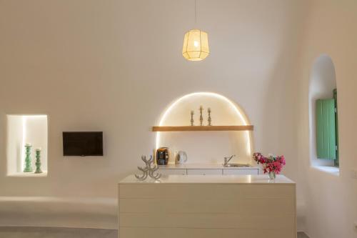 a bathroom with a sink and a mirror at Ayoba Santorini in Imerovigli