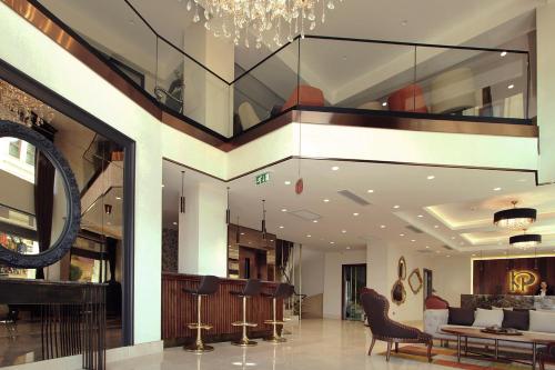 a lobby of a building with a chandelier at Pisa Hotel in Istanbul
