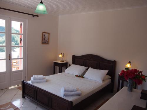 a bedroom with a bed with towels on it at Eolos Apartments with Private Parking in Agios Nikitas