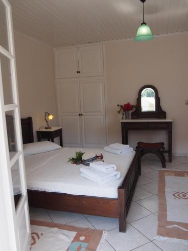 a bedroom with two beds and a table with towels at Eolos Apartments with Private Parking in Agios Nikitas