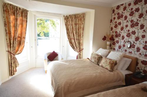 a bedroom with two beds and a window at Wereham House in Thetford