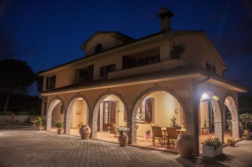 a large building with an archway at night at Villa Mandrioli in Cecina