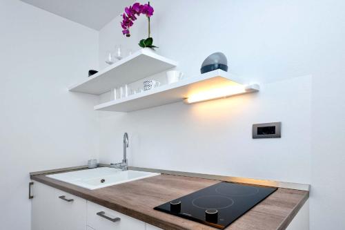 a kitchen with a sink and a counter top at Villa Sego in Hvar