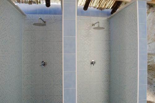 a bathroom with a shower with blue tiles at Hotel Regina del Mare in Ischia