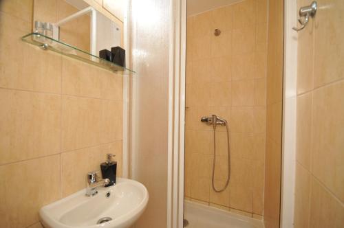 a bathroom with a sink and a shower at Penzión Pastierňa in Dedinky