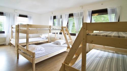 two bunk beds in a room with windows at Hotel & Hostel 10 in Gothenburg