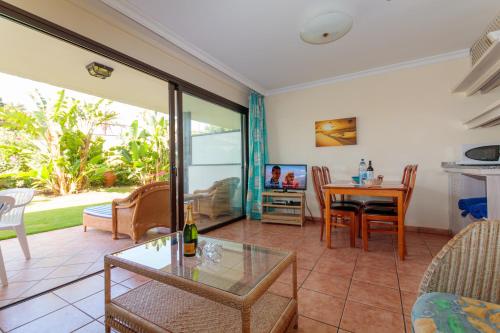 a living room with a table and a dining room at VIP Apartamentos Nogal- Adults Only in Playa del Ingles