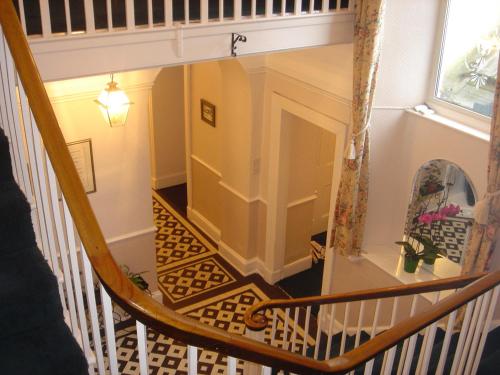 a spiral staircase in a house with a room at Croft Hill Guest House in Whitehaven