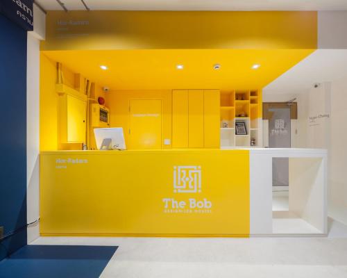 a yellow booth at the job exhibition booth at The BoB Hostel in Bangkok