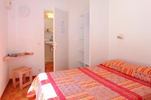 a small bedroom with a bed and a closet at Village Vacances La Manne in Bormes-les-Mimosas