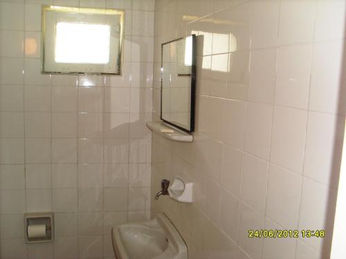 a bathroom with a sink and a mirror and a toilet at Kiyak Hotel in Demre