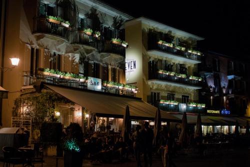 a large building with people standing around it at Seven Boutique Hotel in Ascona
