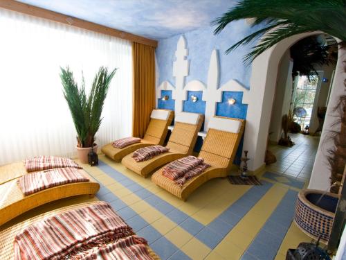 a room with four chairs and a wall with a mural at Landhotel Grimmeblick in Winterberg