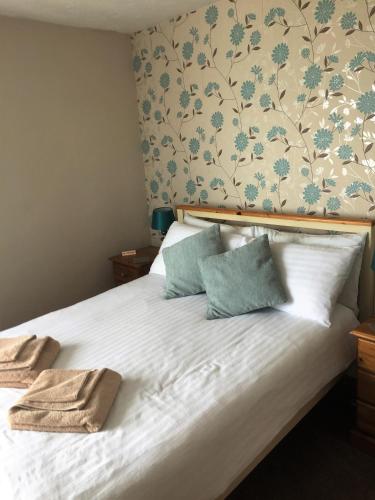 a bedroom with a bed with two towels on it at The Beach House in Weymouth
