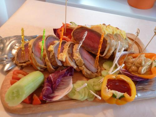 a plate of food with meat and vegetables on a table at Hotel Karl in Železná Ruda