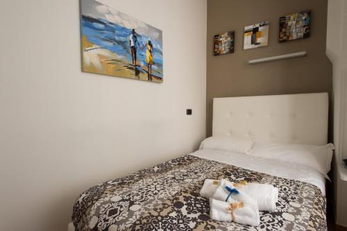 a bedroom with a bed with towels on it at boutique apartment al duomo in Salerno