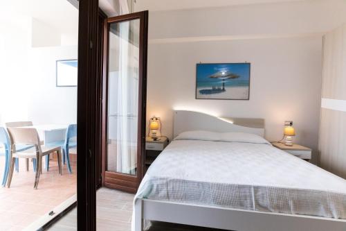 a bedroom with a bed and a table and chairs at Il Grecale case vacanza in Crotone