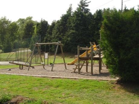 a park with a playground with a slide at Résidence Les Dômes in Murol