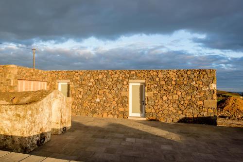 a stone wall with a door on a building at Casa Branca da Vaquinha in Angra do Heroísmo