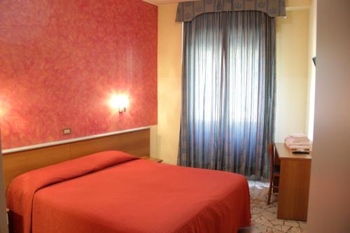 Un pat sau paturi într-o cameră la Hotel Del Sud