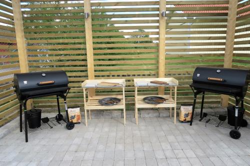 two stools sitting next to a table with two stoves at Easy Livin' Apartment Hotel in Växjö