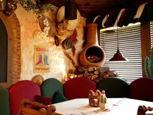 a restaurant with a table and chairs with a fireplace at Landhotel Grimmeblick in Winterberg