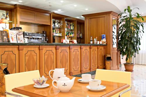 a table with chairs and a bar in a restaurant at Hotel Centro di Spiritualità Padre Pio in San Giovanni Rotondo
