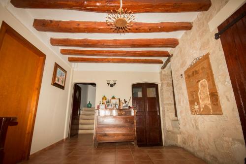 a hallway in a house with wooden ceilings at Cal Manyo in Puigvert de Lérida