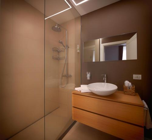 a bathroom with a sink and a shower at Lainez Rooms & Suites in Trento