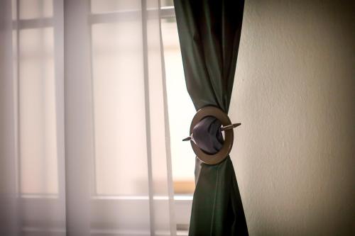 a curtain on a wall next to a window at Lainez Rooms & Suites in Trento