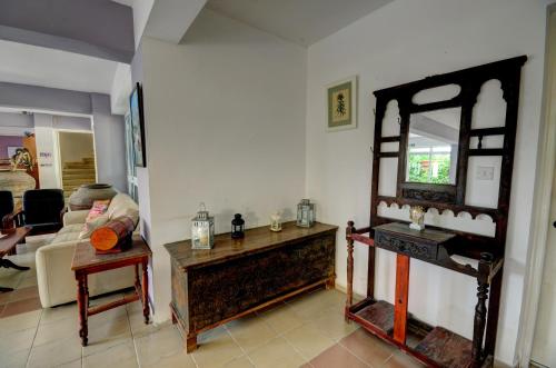 a living room with a table and a mirror at Renos Apartments in Polis Chrysochous