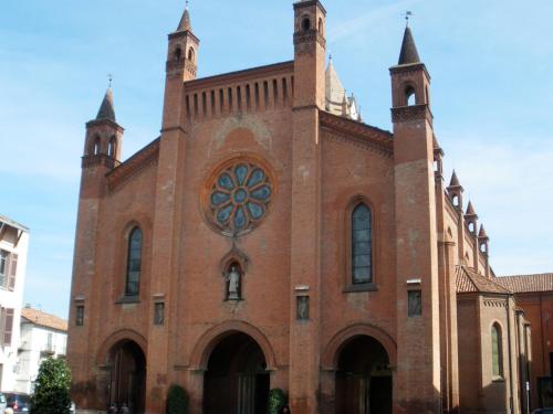 a large brick church with two towers on top at Albergo San Lorenzo in Alba