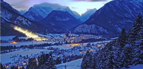 a town in a valley with snow covered mountains at Mountain View Apartments - Pr` Potovcn`k in Dovje