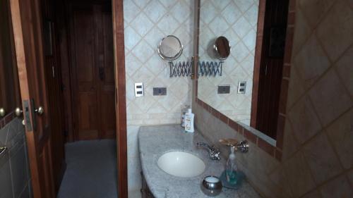a bathroom with a sink and a mirror at Great Chalet Farellones in Farellones