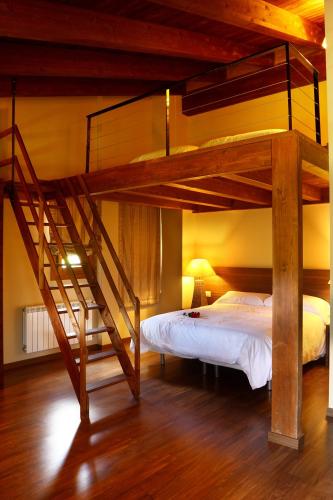 a bedroom with a bunk bed and a staircase at El Cierzo de Javalambre in Arcos de las Salinas