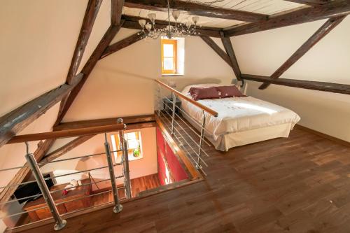 a bedroom with a bed in a attic at La Maison d'Emilie in Pfaffenheim
