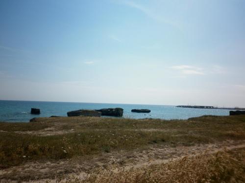 a view of the ocean with rocks in the water at Villino sul mare in San Foca
