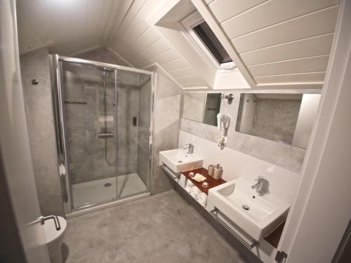 a bathroom with a shower and a sink at Manta Ray Lodge in Horta