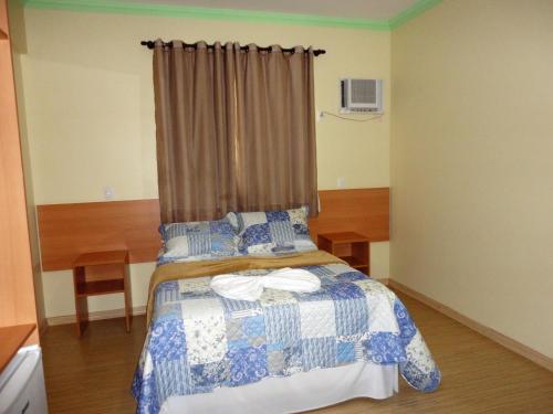 Brasil Center Hotel tesisinde bir odada yatak veya yataklar