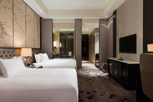 Cama o camas de una habitación en Wanda Realm Nanjing
