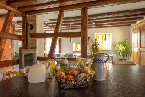 a kitchen with a table with a basket of bread at La Maison d'Emilie in Pfaffenheim
