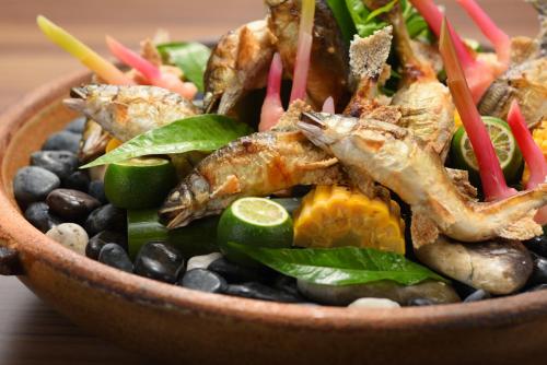 a bowl of food with fish and black beans at Sakunami Onsen Yuzukushi Salon Ichinobo in Sendai