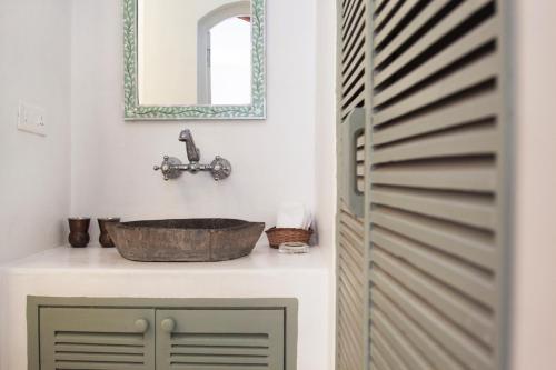 a bathroom with a sink and a mirror at Ahilya By The Sea in Nerul