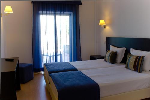 En eller flere senger på et rom på Casa Do Vale Hotel