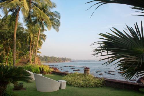 a view of the ocean from a resort with palm trees at Ahilya By The Sea in Nerul