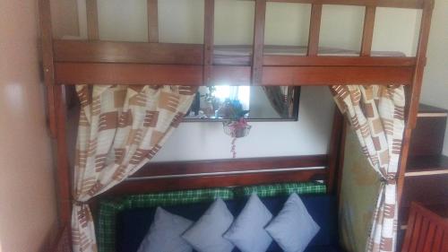 a bunk bed with pillows in a room at Tagaytay Winds in Tagaytay