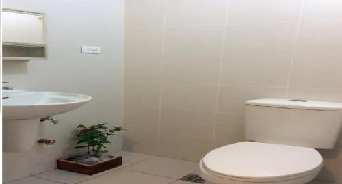 a bathroom with a toilet and a sink at Tagaytay Winds in Tagaytay