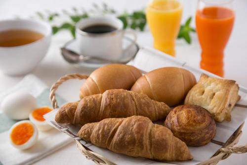 a tray of bread and croissants and a cup of coffee at R&B Hotel Kumamoto Shimotori in Kumamoto